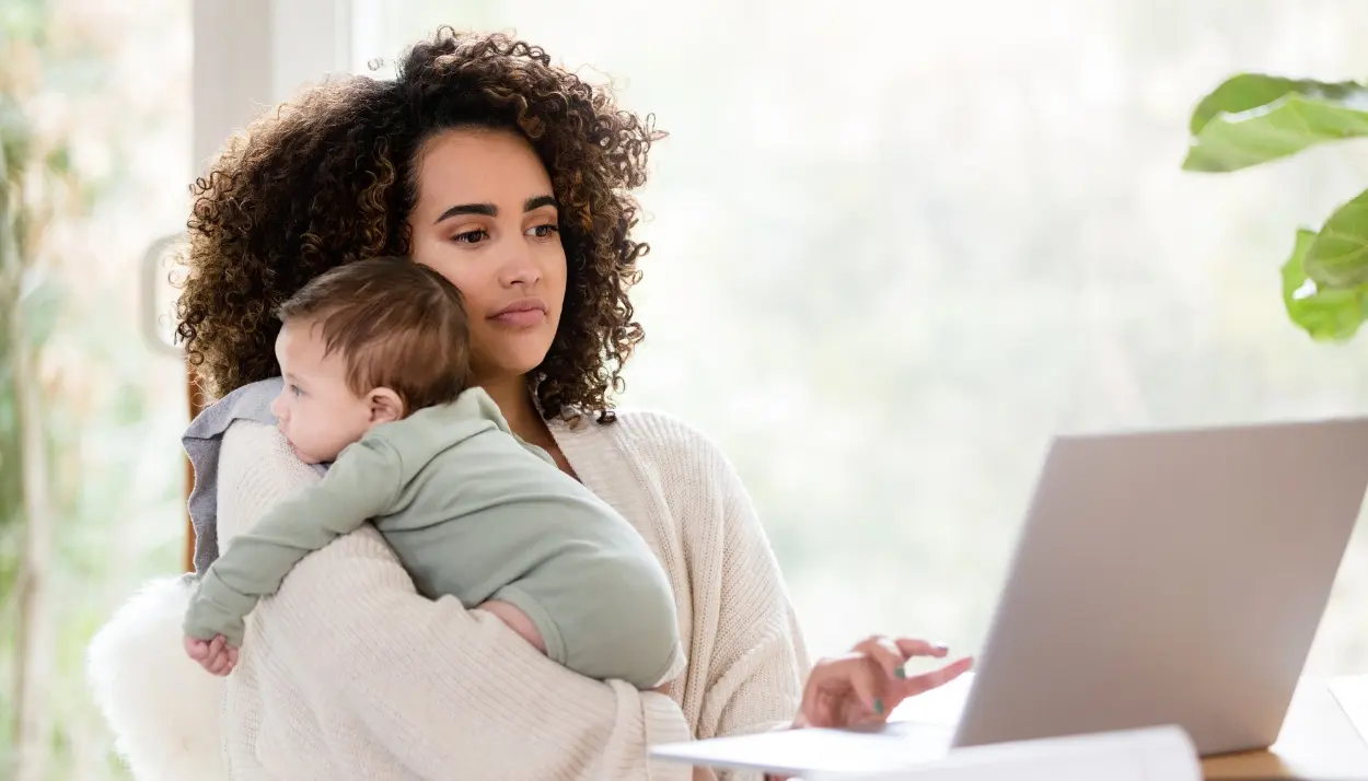 working woman with her baby in front of a computer