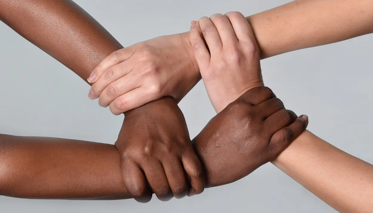 two persons joining hands