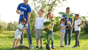 volunteers with children, planting trees