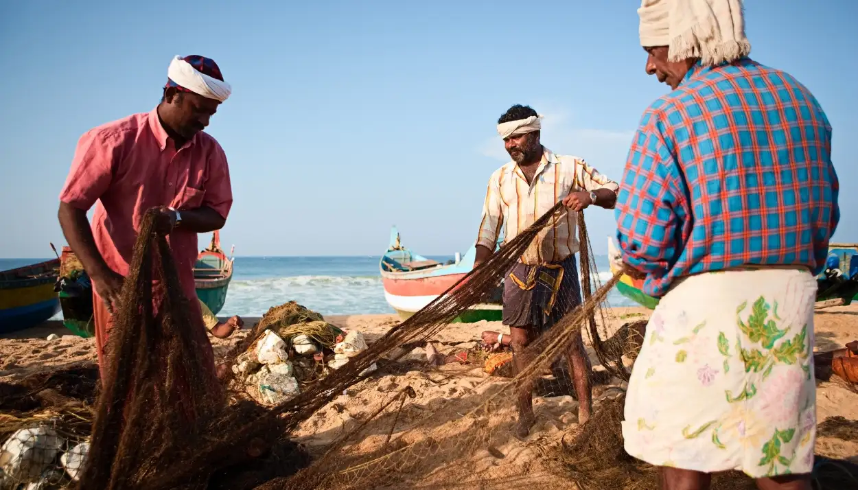 three fishermen laboring a net