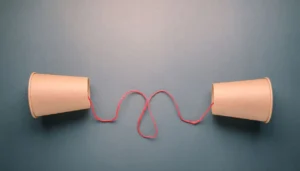 two paper cups and a string representing a form of transmitting information