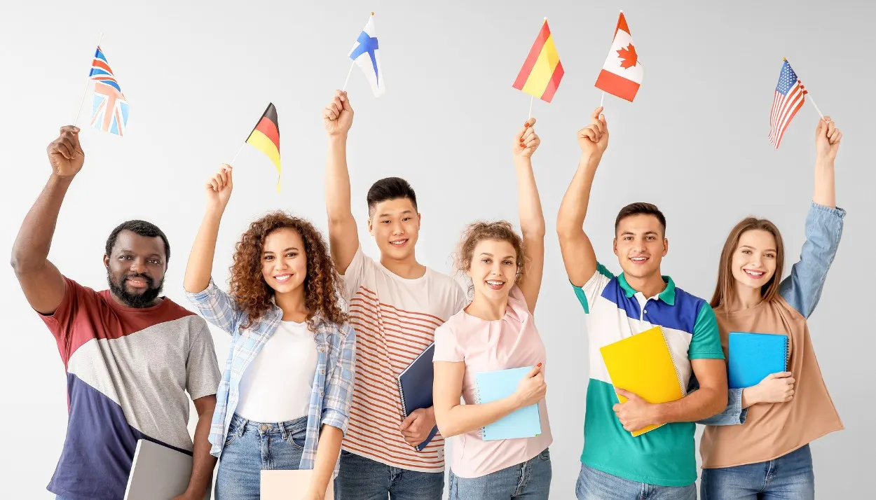 an intercultural work team showing their national flags